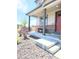 Inviting front porch featuring neutral siding, brick accents, seating, and manicured landscaping at 13315 Xanthia St, Thornton, CO 80602