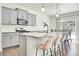 Modern kitchen featuring granite countertops, stainless steel appliances, and a breakfast bar at 13315 Xanthia St, Thornton, CO 80602