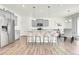 Bright, spacious kitchen with granite countertops, stainless steel appliances, and stylish barstool seating at 13315 Xanthia St, Thornton, CO 80602