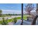 This inviting porch features comfortable seating with scenic views and lush landscaping at 13315 Xanthia St, Thornton, CO 80602