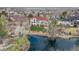 Aerial view of backyard with mature landscaping, a stone fire pit and a beautiful water feature at 16 Blue Heron Dr, Thornton, CO 80241