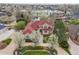 Beautiful aerial view of the home, its beautiful mature landscaping, and the lake at 16 Blue Heron Dr, Thornton, CO 80241