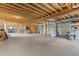 Unfinished basement with exposed beams, concrete floor, and utilities hookups ready for finishing at 16 Blue Heron Dr, Thornton, CO 80241
