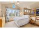 Bedroom with large window, vaulted ceiling, and ladder that leads to an elevated second floor at 16 Blue Heron Dr, Thornton, CO 80241