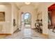 Inviting foyer with tile flooring, decorative accents, and an open view to the front yard through an arched doorway at 16 Blue Heron Dr, Thornton, CO 80241