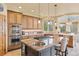 Gourmet kitchen featuring a granite island, stainless steel appliances, and custom cabinetry at 16 Blue Heron Dr, Thornton, CO 80241