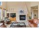 Cozy living room with a stone fireplace, comfortable seating, and built-in media center at 16 Blue Heron Dr, Thornton, CO 80241