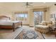 Serene main bedroom featuring a sitting area, large windows, and a comfortable king-size bed at 16 Blue Heron Dr, Thornton, CO 80241