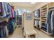 Spacious walk-in closet with custom shelving and abundant storage, including bench seating at 16 Blue Heron Dr, Thornton, CO 80241