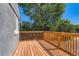 This is a view of a wood back deck area with wood railings and view of trees at 695 S Quitman St, Denver, CO 80219