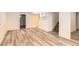Large basement living area with wood-look flooring, white walls and stairs at 695 S Quitman St, Denver, CO 80219