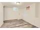 Finished basement space features wood look floors and a small window at 695 S Quitman St, Denver, CO 80219
