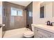 Modern bathroom with gray tiled shower, white vanity and dark fixtures at 695 S Quitman St, Denver, CO 80219