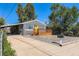 Street view of a cozy home with a new wooden porch and carport in a quiet neighborhood at 695 S Quitman St, Denver, CO 80219