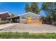 Charming single-story home featuring a new wooden porch and bright yellow front door at 695 S Quitman St, Denver, CO 80219