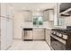 Modern kitchen showcasing gray cabinetry, stainless steel appliances, and subway tile backsplash at 695 S Quitman St, Denver, CO 80219