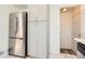 Bright kitchen with stainless steel refrigerator, white cabinets, and marble tile flooring at 695 S Quitman St, Denver, CO 80219