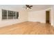 Bright living room featuring hardwood floors, a large window, and a modern ceiling fan at 695 S Quitman St, Denver, CO 80219