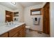 Clean bathroom featuring a single sink vanity with wooden cabinets and a framed mirror above at 26452 Wolverine Trl, Evergreen, CO 80439