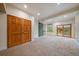 A large room with carpeting and a sliding green door at 26452 Wolverine Trl, Evergreen, CO 80439