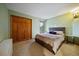Comfortable bedroom features a large window, wall decor, and a bed with decorative pillows at 26452 Wolverine Trl, Evergreen, CO 80439