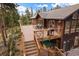 Multi-tiered deck featuring a grill and stylish railings, ideal for outdoor cooking and enjoying the scenic surroundings at 26452 Wolverine Trl, Evergreen, CO 80439
