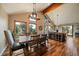 Open dining area with wood floors, large windows with scenic views, and modern lighting fixture at 26452 Wolverine Trl, Evergreen, CO 80439