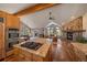 Open concept kitchen with a granite island and breakfast bar, overlooking the living room at 26452 Wolverine Trl, Evergreen, CO 80439