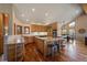 Spacious kitchen with granite countertops, island gas cooktop, stainless oven, and hardwood floors at 26452 Wolverine Trl, Evergreen, CO 80439