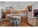Spacious kitchen with wood cabinets, granite countertops, island with seating, and stainless steel appliances at 26452 Wolverine Trl, Evergreen, CO 80439