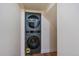 Laundry room showcasing a sleek, stacked washer and dryer unit at 26452 Wolverine Trl, Evergreen, CO 80439