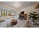 The living room has a stone fireplace with a mounted tv and a large window at 26452 Wolverine Trl, Evergreen, CO 80439
