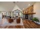 Inviting living room features a stone fireplace, vaulted ceilings, large windows, and hardwood floors at 26452 Wolverine Trl, Evergreen, CO 80439