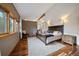 Comfortable bedroom with wood floors, natural light, and ensuite bath at 26452 Wolverine Trl, Evergreen, CO 80439