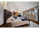 Spacious bedroom features hardwood floors, lots of natural light, and ensuite bath at 26452 Wolverine Trl, Evergreen, CO 80439