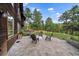 Stone patio with comfortable seating, offering a relaxing outdoor space for gatherings and enjoying the surrounding landscape at 26452 Wolverine Trl, Evergreen, CO 80439