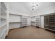 Spacious walk-in closet with ample shelving and hanging space under a decorative chandelier at 26452 Wolverine Trl, Evergreen, CO 80439