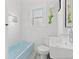 Bathroom featuring a modern sink, subway tile, and a tub with a blue tile border at 1804 S Corona St, Denver, CO 80210