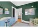 Green Bedroom features a blue dresser and pops of color from books and artwork at 1804 S Corona St, Denver, CO 80210