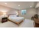 Finished basement bedroom featuring neutral tones, minimalist furniture, and ample natural light at 1804 S Corona St, Denver, CO 80210