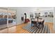 Bright dining area with hardwood floors, modern lighting, and a charming wood-burning stove at 1804 S Corona St, Denver, CO 80210