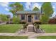 Charming home featuring a well-manicured lawn, inviting front steps, and lovely landscaping at 1804 S Corona St, Denver, CO 80210