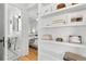 Hallway with floating shelves leads from the bathroom to the bright main bedroom at 1804 S Corona St, Denver, CO 80210