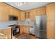 Well-equipped kitchen featuring stainless steel appliances, and wooden cabinetry at 1804 S Corona St, Denver, CO 80210