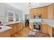 Well-lit kitchen with wooden cabinets and stainless steel oven at 1804 S Corona St, Denver, CO 80210