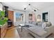 Cozy living room with a brick fireplace, large sectional sofa, and plenty of natural light at 1804 S Corona St, Denver, CO 80210