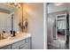 Neutral bathroom featuring a white tiled counter with a modern faucet and a glimpse into the bedroom at 10330 Lions Path, Lone Tree, CO 80124