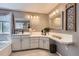 Bright bathroom featuring dual vanities, white cabinets, updated mirrors and lighting, a separate tub, and a window at 10330 Lions Path, Lone Tree, CO 80124