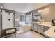 Comfortable primary bathroom with shower and tub, updated counters and vanity, and updated lighting at 10330 Lions Path, Lone Tree, CO 80124