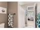 Cozy bathroom featuring a shower with a patterned white curtain and a charming green and white towel at 10330 Lions Path, Lone Tree, CO 80124